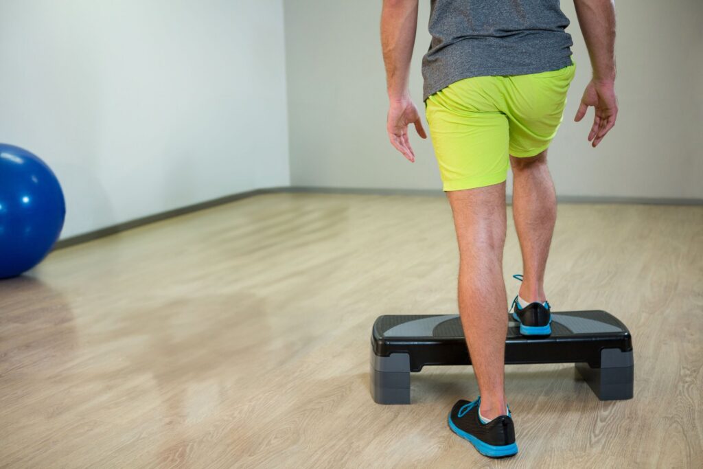 man in neon shorts stepping onto platform in fitne 2026 03 26 07 56 52 utc